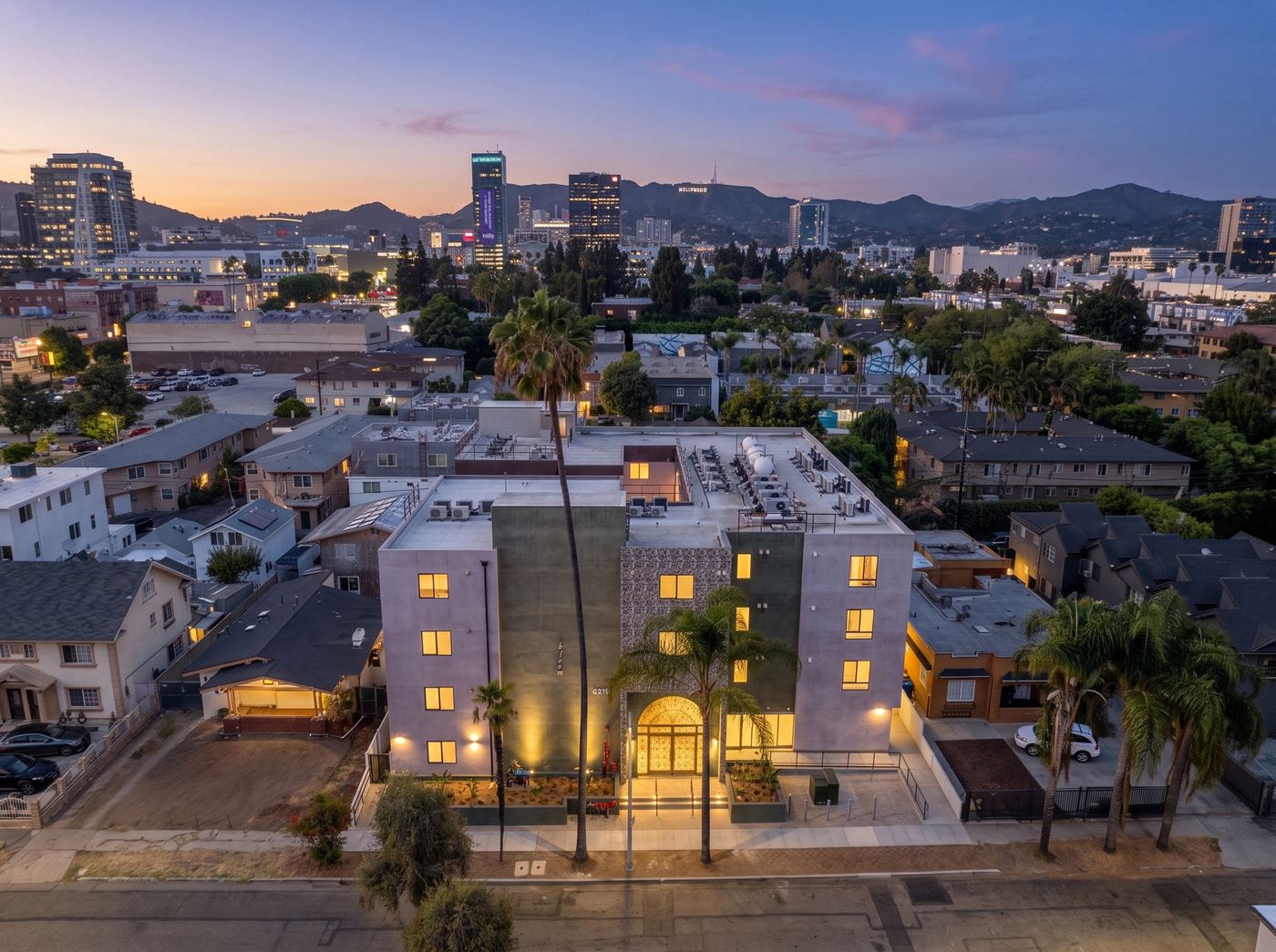 The building from the air at dusk, with the Hollywood Hills and nearby streets in the background.